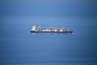 Ship in sea against clear blue sky