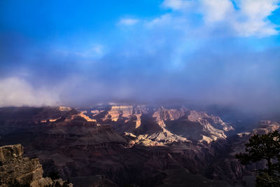 Aerial view of mountain range against cloudy sky