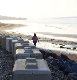 Rear view of man standing on beach