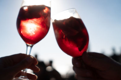Close-up of hand holding red wine