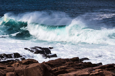 Waves breaking on rocks at beach