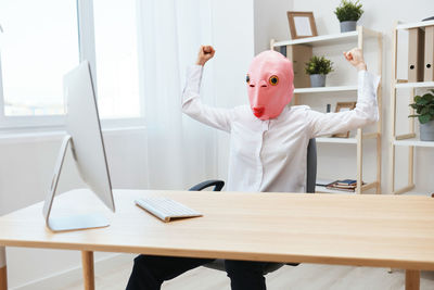 Midsection of woman using laptop on table