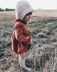 Full length of toddler girl standing on field