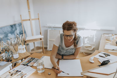 Artist painting in studio