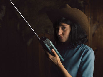 Portrait of young woman using walkie-talkie