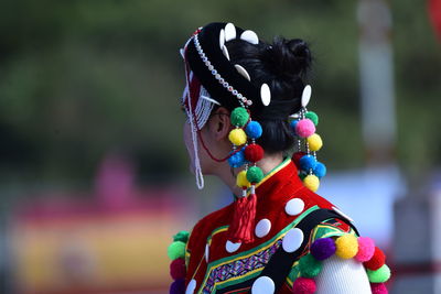 Woman in traditional clothing standing outdoors