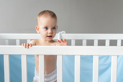 Portrait of cute baby boy sleeping on bed at home