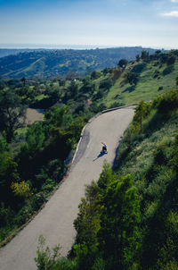 High angle view of man longboarding on mountain road