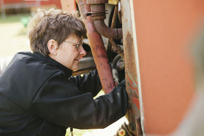 Woman repairing tractor
