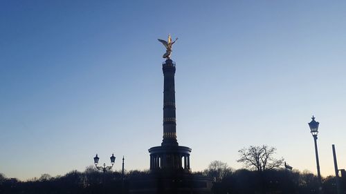 Low angle view of statue against blue sky