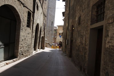 Narrow street amidst buildings in city