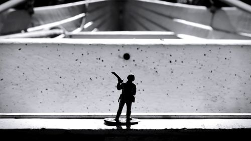 Rear view of silhouette man standing in bus