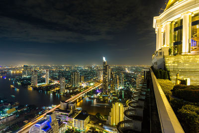 High angle view of city lit up at night