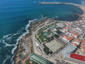 High angle view of sea and buildings in city