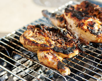 Close-up of chicken meat on barbecue grill