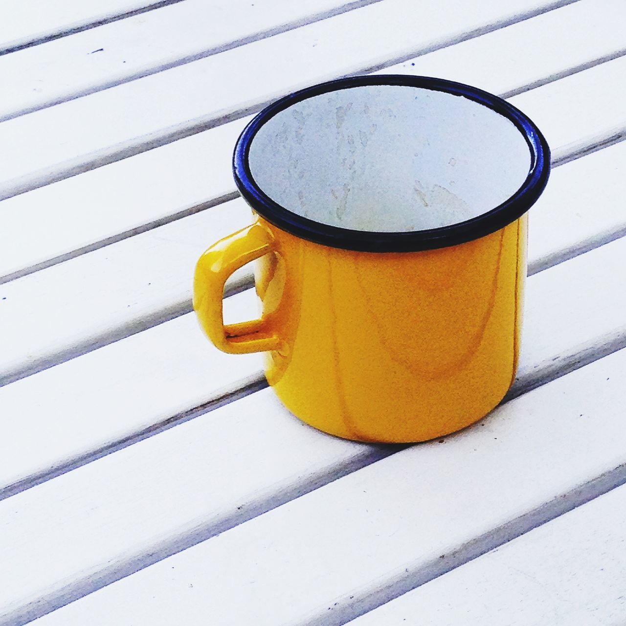 yellow, still life, indoors, table, close-up, high angle view, no people, food and drink, drink, day, orange color, shadow, metal, sunlight, pattern, directly above, empty, wood - material, refreshment, coffee cup