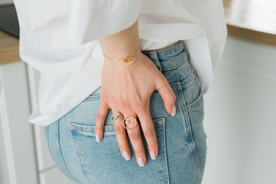 Midsection of bride holding abdomen