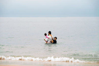 Father with children in sea