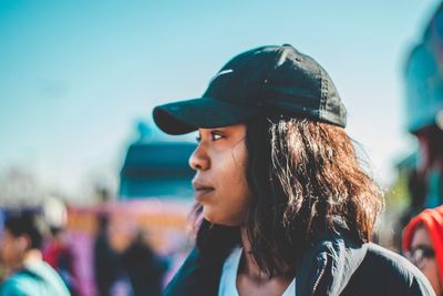 Close-up portrait of a young woman looking away