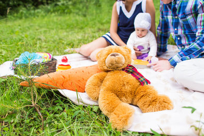 Rear view of women sitting on grass