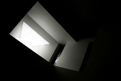 Low angle view of illuminated lamp at night