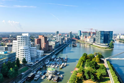 High angle view of buildings and trees against sky