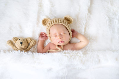 Cute baby girl sleeping on bed at home