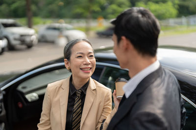 Portrait of smiling couple standing in city