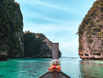 Rock formations by sea against sky
