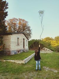 Full length of child on grassy field against clear sky