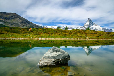 Scenic view of lake and mountains against sky