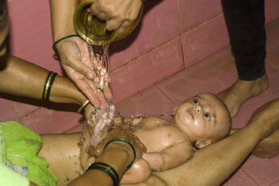 High angle view of woman holding wet hand