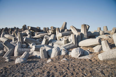 Low angle view of stack of rocks on beach against clear sky