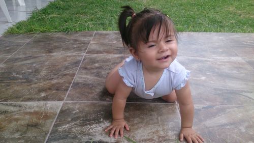 Girl looking away while sitting on floor