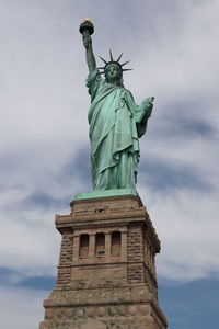 Low angle view of statue against cloudy sky