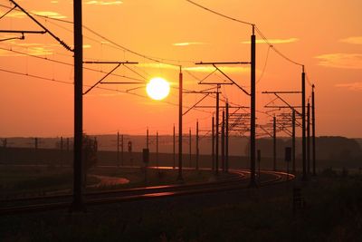 Railroad tracks against sky during sunset