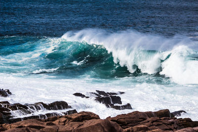 Waves splashing on rocks at shore