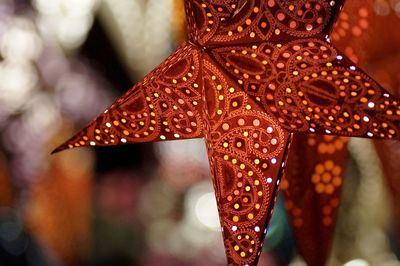 Close-up of star shaped lantern hanging outdoors at night