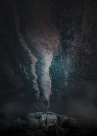 Person standing on rock formation