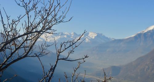 Scenic view of mountains against blue sky