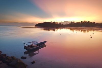 Scenic view of lake against sky during sunset