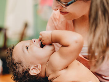 Midsection of woman with baby