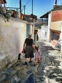 Full length of girl standing in front of building