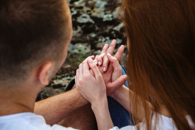 Rear view of couple holding hands