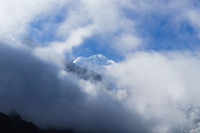 Scenic view of clouds and mountains against sky