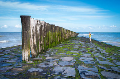 View of calm beach against blue sky