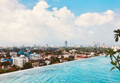 View of swimming pool by sea against sky