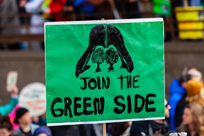 Close-up of information sign against blurred background
