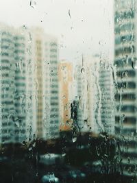 Buildings seen through wet window during rainy season