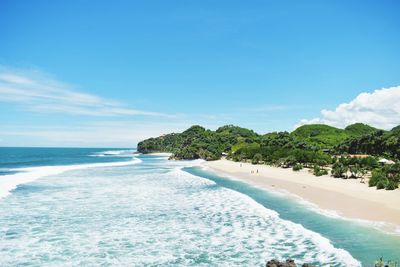 Scenic view of beach against blue sky